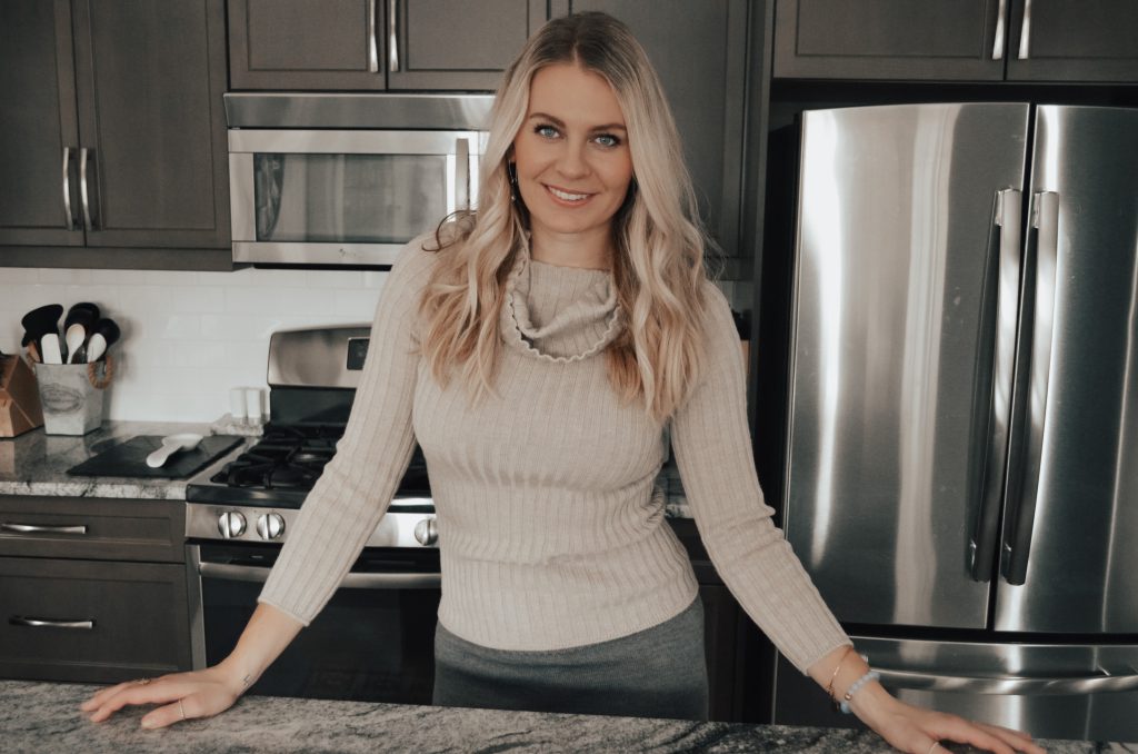 Kelsey, the founder of Gut Healthy Dietitian, in her kitchen