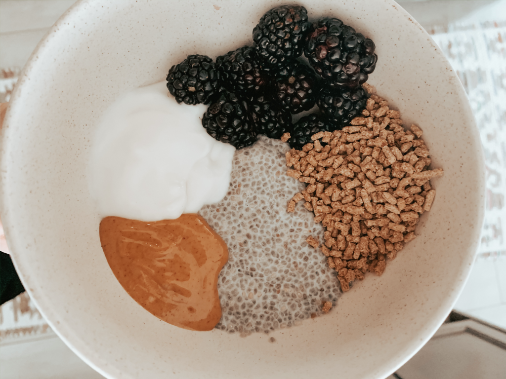 Chia pudding served with yogurt, peanut butter, bran and blackberries